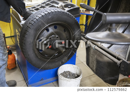 Car wheel repair in a tire workshop. Car wheel repair in a tire workshop. 112579862