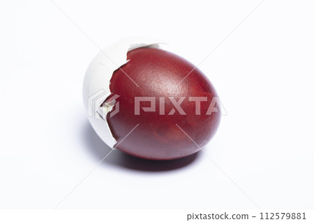Classic easter egg painted with onion peel close-up on a white background 112579881