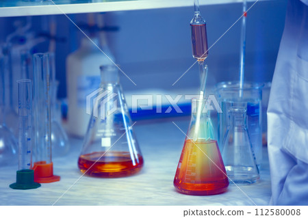 Vaccine production laboratory. Glass flasks with a chemical liquid in infrared radiation. Vaccine production laboratory. Glass flasks with a chemical liquid in infrared radiation. 112580008