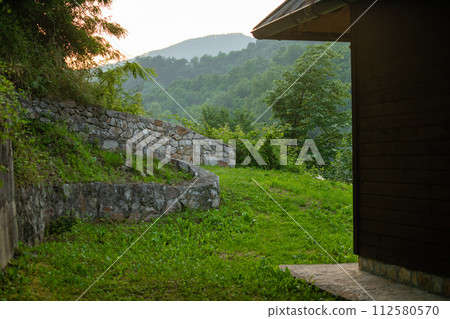 Porch of a wooden house in the forest on the river bank 112580570