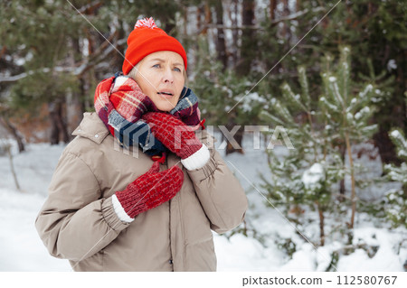 Mature woman in warm clothes having sore throat 112580767
