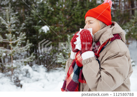 Woman in red hat having running nose and feeling unwell Woman in red hat having running nose and feeling unwell 112580788