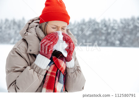 Woman in red hat having running nose and feeling unwell Woman in red hat having running nose and feeling unwell 112580791