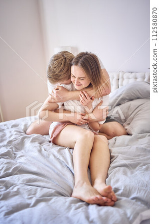 tender embrace of young man and woman at home 112580870