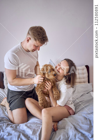 a couple gently hugs and kisses a cockapoo girl, minimalism a couple gently hugs and kisses a cockapoo girl, minimalism 112580891