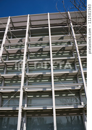 A building designed with regular square windows A building designed with regular square windows 112581563