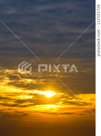 Sky with cirrus clouds and bright sunrise. Vertical photo Sky with cirrus clouds and bright sunrise. Vertical photo 112581726