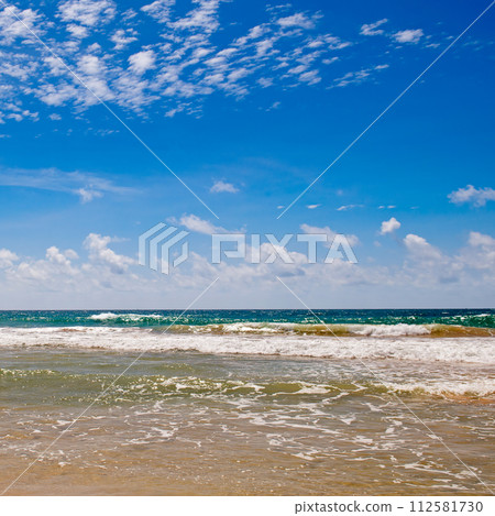 Scenic beach and sky with beautiful cumulus clouds. 112581730