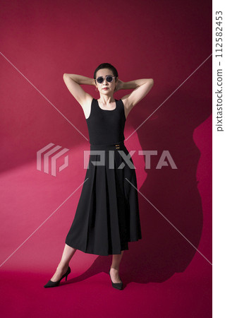 A woman in a black dress A woman in a black dress 112582453