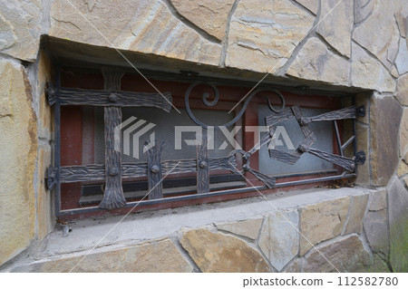 Old iron shod window bar, vintage handmade. Uzhgorod, Ukraine Old iron shod window bar, vintage handmade. Uzhgorod, Ukraine 112582780