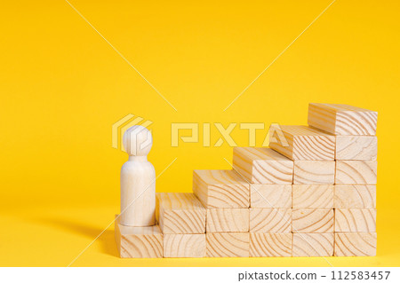 Businessman climbing stairs. Business success process, career ladder. Wooden figurine 112583457