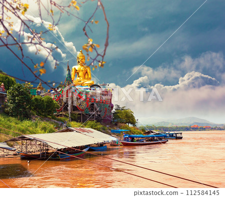 Golden giant Buddha statue on Mekong river. Golden giant Buddha statue on Mekong river. 112584145