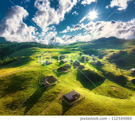 Aerial view of old mountain village on the green hills at sunset Aerial view of old mountain village on the green hills at sunset 112584868