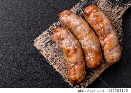 Grilled sausages with spices and herbs. With copy space Grilled sausages with spices and herbs. With copy space 112585150