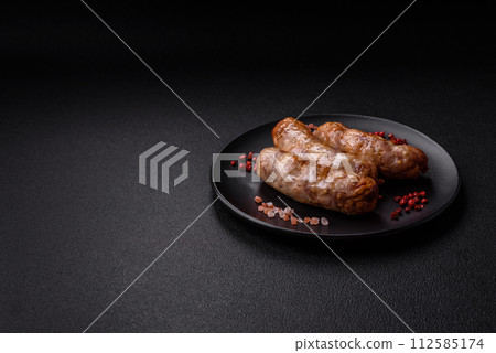 Grilled sausages with spices and herbs. With copy space 112585174