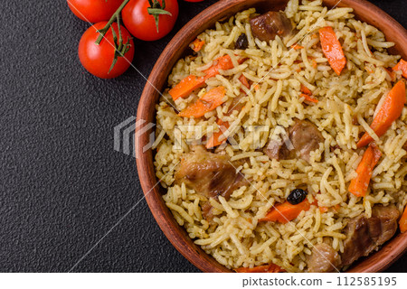 Delicious pilaf with vegetables, salt, spices and herbs in a ceramic plate Delicious pilaf with vegetables, salt, spices and herbs in a ceramic plate 112585195