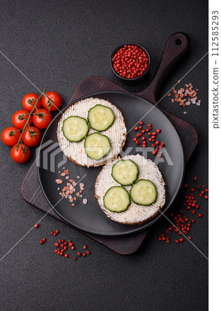 Delicious vegetarian sandwich with grilled toast, cream cheese, cucumbers and seeds Delicious vegetarian sandwich with grilled toast, cream cheese, cucumbers and seeds 112585293