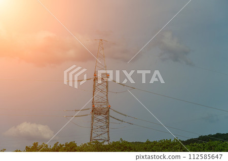 High voltage towers with sky background. Power line support with wires for electricity transmission. High voltage grid tower with wire cable at distribution station. Energy industry, energy saving High voltage towers with sky background. Power line support with wires for electricity transmission. High voltage grid tower with wire cable at distribution station. Energy industry, energy saving 112585647