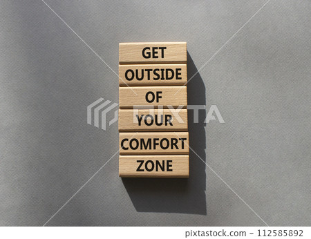 Get outside of your comfort zone symbol. Concept words Get outside of your comfort zone on wooden blocks. Beautiful grey background. Business concept. Copy space. Get outside of your comfort zone symbol. Concept words Get outside of your comfort zone on wooden blocks. Beautiful grey background. Business concept. Copy space. 112585892