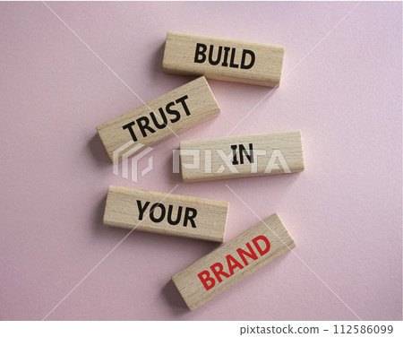 Build trust in your brand symbol. Wooden blocks with words Build trust in your brand. Beautiful pink background. Business and Build trust in your brand concept. Copy space. Build trust in your brand symbol. Wooden blocks with words Build trust in your brand. Beautiful pink background. Business and Build trust in your brand concept. Copy space. 112586099