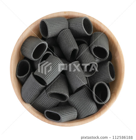 Black pasta with cuttlefish ink in wooden bowl isolated on white background. Top view. Flat lay Black pasta with cuttlefish ink in wooden bowl isolated on white background. Top view. Flat lay 112586188