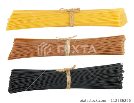 uncooked black, brown and yellow spaghetti isolated on white background 112586296