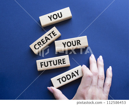 Future and development symbol. Wooden blocks with words You Create your Future today. Businessman hand. Beautiful deep blue background. Business and Future and development concept. Copy space. Future and development symbol. Wooden blocks with words You Create your Future today. Businessman hand. Beautiful deep blue background. Business and Future and development concept. Copy space. 112586453