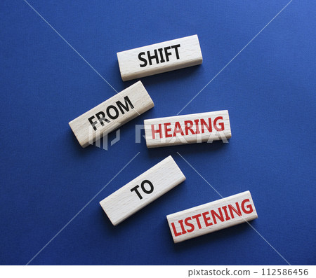 Listening symbol. Wooden blocks with words Shift from Hearing to Listening. Beautiful deep blue background. Business and Listening concept. Copy space. Listening symbol. Wooden blocks with words Shift from Hearing to Listening. Beautiful deep blue background. Business and Listening concept. Copy space. 112586456