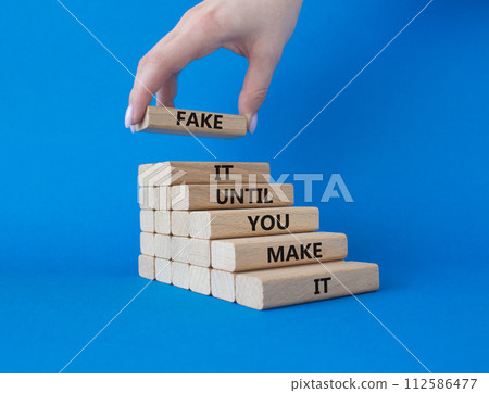 Fake it until you make it symbol. Concept words Fake it until you make it on wooden blocks. Businessman hand. Beautiful blue background. Business concept. Copy space. Fake it until you make it symbol. Concept words Fake it until you make it on wooden blocks. Businessman hand. Beautiful blue background. Business concept. Copy space. 112586477
