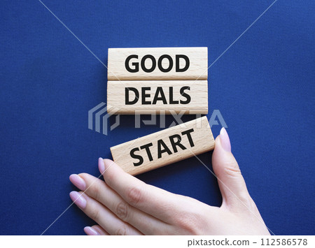 Good Deals Start symbol. Concept words Good Deals Start on wooden blocks. Businessman hand. Beautiful deep blue background. Business concept. Copy space. Good Deals Start symbol. Concept words Good Deals Start on wooden blocks. Businessman hand. Beautiful deep blue background. Business concept. Copy space. 112586578