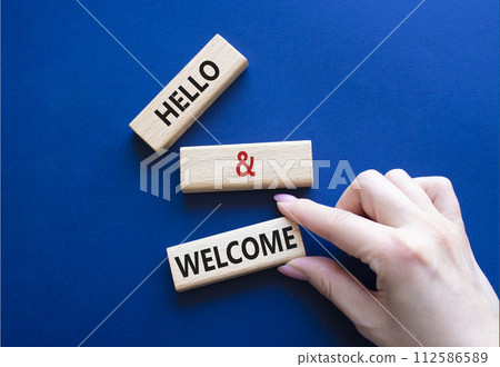 Hello and Welcome symbol. Concept words Hello and Welcome on wooden blocks. Beautiful deep blue background. Businessman hand. Business and Hello and Welcome concept. Copy space. Hello and Welcome symbol. Concept words Hello and Welcome on wooden blocks. Beautiful deep blue background. Businessman hand. Business and Hello and Welcome concept. Copy space. 112586589