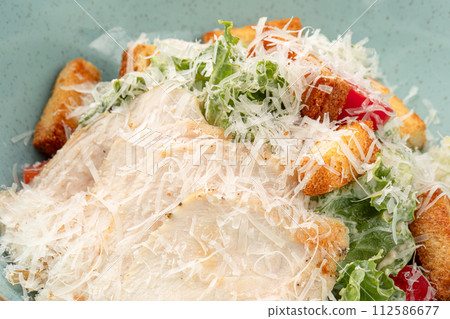 Portion of caesar salad with chicken 112586677