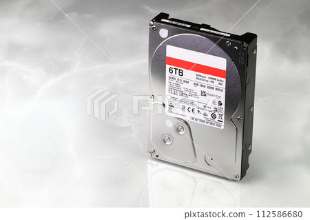 Close up view of high capacity computer hard drive 3.5" in LDPE Packaging isolated on white background. Close up view of high capacity computer hard drive 3.5" in LDPE Packaging isolated on white background. 112586680