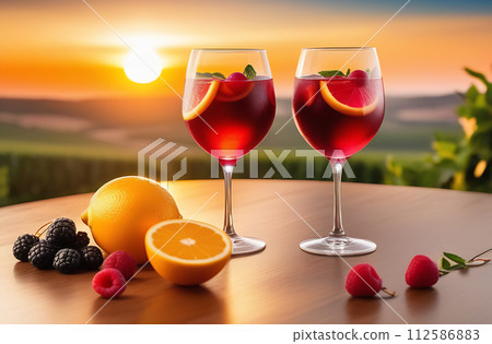 Sangria wineglasses, cold cool summer wine cocktail on table, romantic sunset 112586883