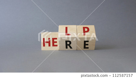 Help is here symbol. Turned wooden cubes with words Here to Help. Beautiful grey background. Business and Help is here concept. Copy space Help is here symbol. Turned wooden cubes with words Here to Help. Beautiful grey background. Business and Help is here concept. Copy space 112587157