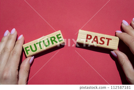 Future or Past symbol. Concept word Future or Past on wooden blocks. Businessman hand. Beautiful red background. Business and Future or Past concept. Copy space 112587181