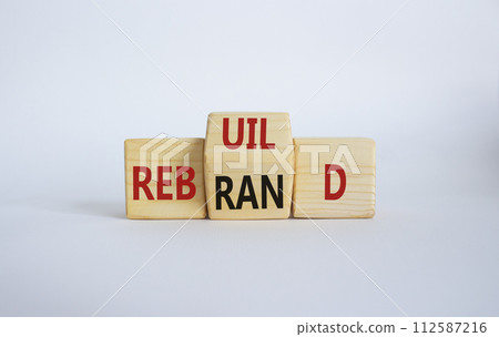 Rebuild and Rebrand symbol. Wooden cubes with words Rebrand and Rebuild. Beautiful white background. Rebuild Rebrand and Business concept. Copy space 112587216