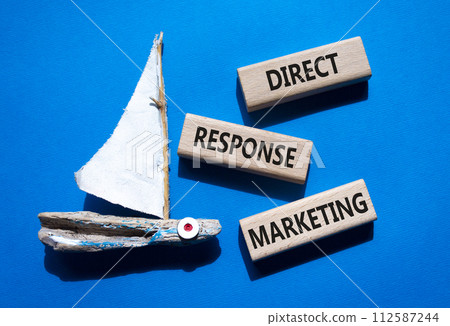 Direct Response Marketing symbol. Concept words Direct Response Marketing on wooden blocks. Beautiful blue background with boat. Business and Direct Response Marketing concept. Copy space. 112587244