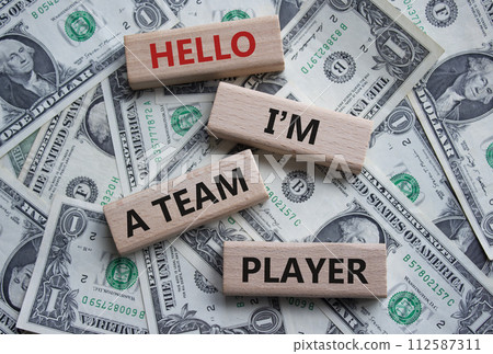 Hello I am a team player symbol. Concept words Hello I am a team player on wooden blocks. Beautiful dollar background. Business and Hello I am a team player concept. Copy space Hello I am a team player symbol. Concept words Hello I am a team player on wooden blocks. Beautiful dollar background. Business and Hello I am a team player concept. Copy space 112587311