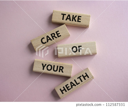Health symbol. Wooden blocks with words Take Care of your Health. Beautiful pink background. Health concept. Copy space. Health symbol. Wooden blocks with words Take Care of your Health. Beautiful pink background. Health concept. Copy space. 112587331