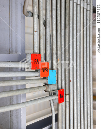 Steel Tube Fitting, Electricity and signal wire tubes attached on wall and ceiling, loft design or concept. Tube for fa, nps, cctv, ltg, pds, tel, cass cable. Steel Tube Fitting, Electricity and signal wire tubes attached on wall and ceiling, loft design or concept. Tube for fa, nps, cctv, ltg, pds, tel, cass cable. 112587371