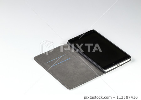 Mobile phone or smart phone in leather case open on white background 112587416