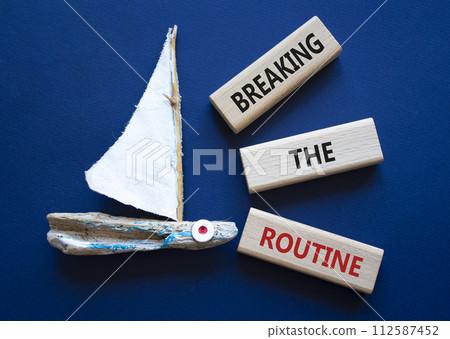 Breaking the Routine week symbol. Concept words Breaking the Routine on wooden blocks. Beautiful deep blue background with boat. Business and Breaking the Routine concept. Copy space 112587452