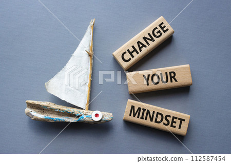 Change your mindset symbol. Concept words Change your mindset on wooden blocks. Beautiful grey background with boat. Business and Change your mindset concept. Copy space. Change your mindset symbol. Concept words Change your mindset on wooden blocks. Beautiful grey background with boat. Business and Change your mindset concept. Copy space. 112587454