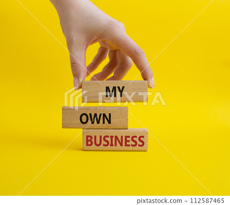 My own Business symbol. Concept words My own Business on wooden blocks. Businessman hand. Beautiful yellow background Business and My own Business concept. Copy space. My own Business symbol. Concept words My own Business on wooden blocks. Businessman hand. Beautiful yellow background Business and My own Business concept. Copy space. 112587465