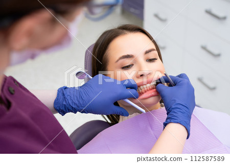 Dentist checking patients bite in a dental clinic. Teeth care concept  112587589