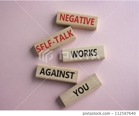 Negative self-talk works against you symbol. Concept words Negative self-talk works against you on wooden blocks. Beautiful pink background. Psychological concept. Copy space Negative self-talk works against you symbol. Concept words Negative self-talk works against you on wooden blocks. Beautiful pink background. Psychological concept. Copy space 112587640