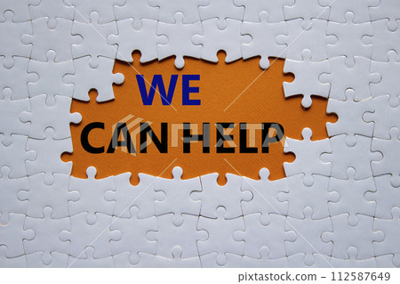 We can help symbol. Concept words We can help on white puzzle. Beautiful orange background. Business and We can help concept. Copy space. 112587649