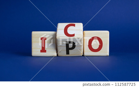 ICO and IPO symbol. Wooden cubes with words ICO - initial coin offering and IPO - initial public offering. Beautiful deep blue background. Business concept. Copy space 112587725