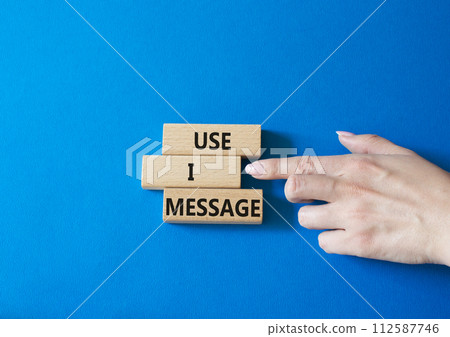 Use I message symbol. Concept word Use I message on wooden blocks. Businessman hand. Beautiful blue background. Business and Use I message concept. Copy space. Use I message symbol. Concept word Use I message on wooden blocks. Businessman hand. Beautiful blue background. Business and Use I message concept. Copy space. 112587746
